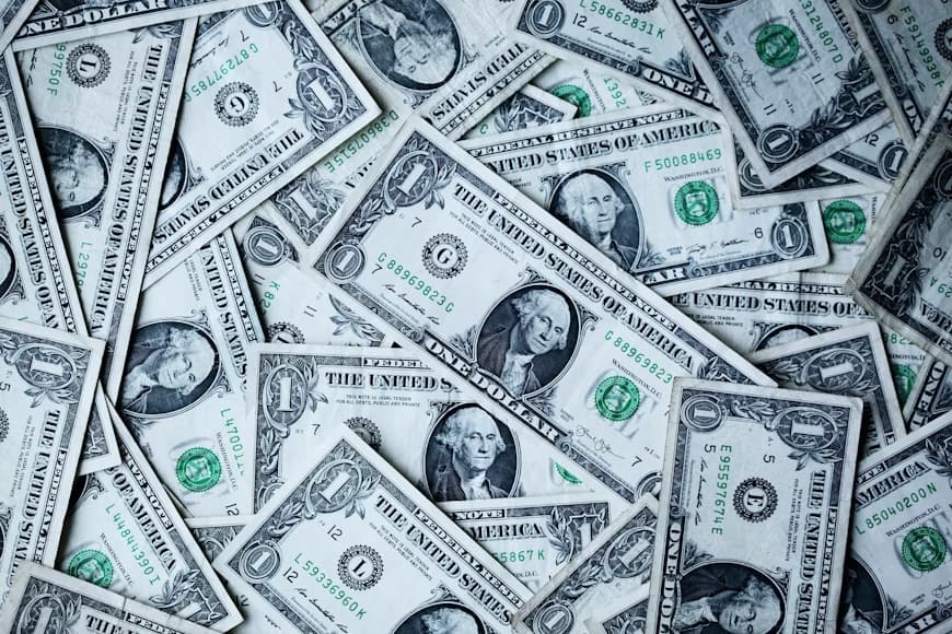 Pile of scattered US one-dollar bills filling the frame
